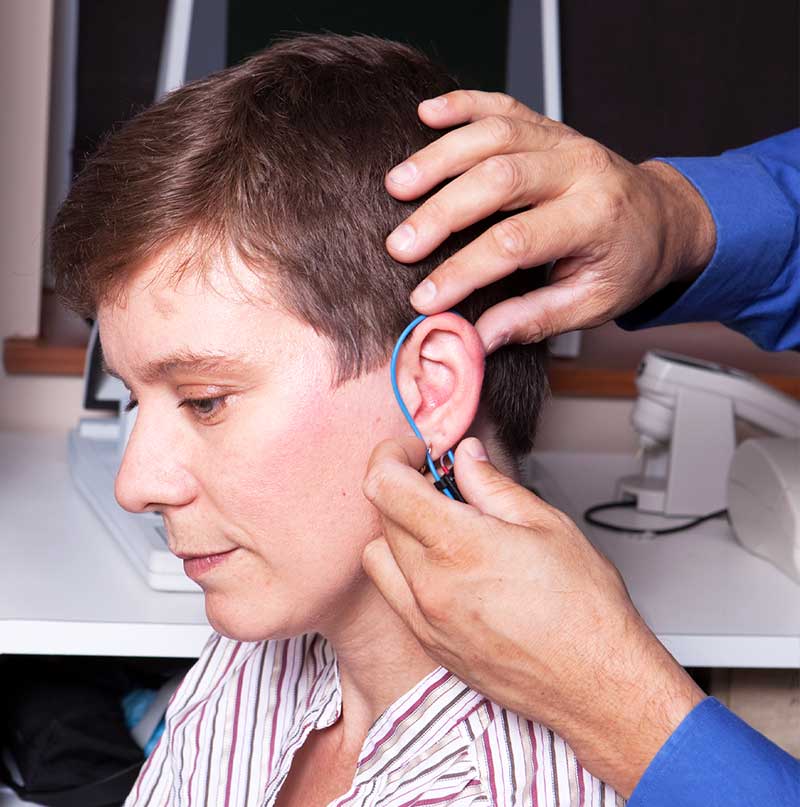 A Real Ear measurement test being performed by an audiologist.